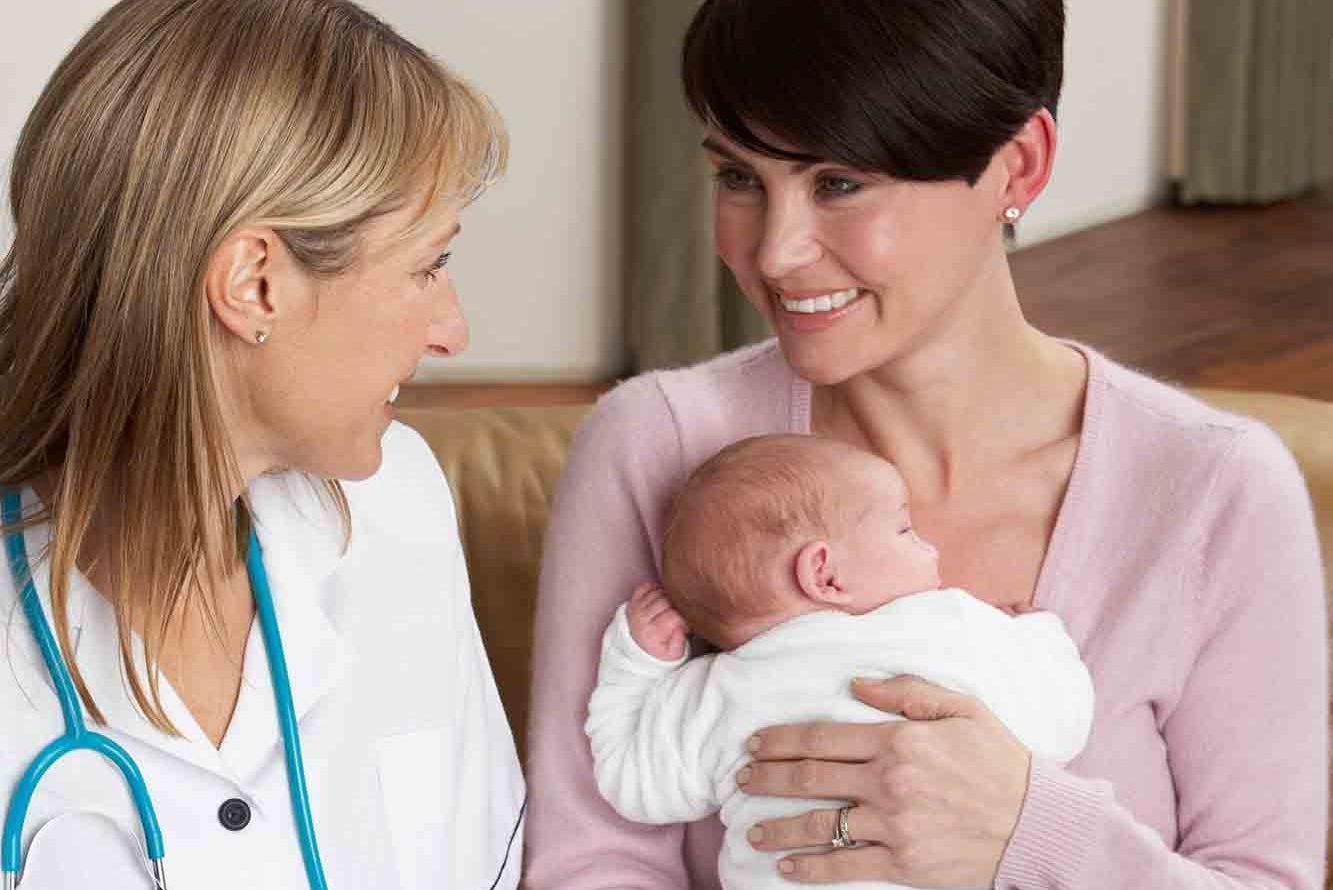 Mother with baby talking to the doctor